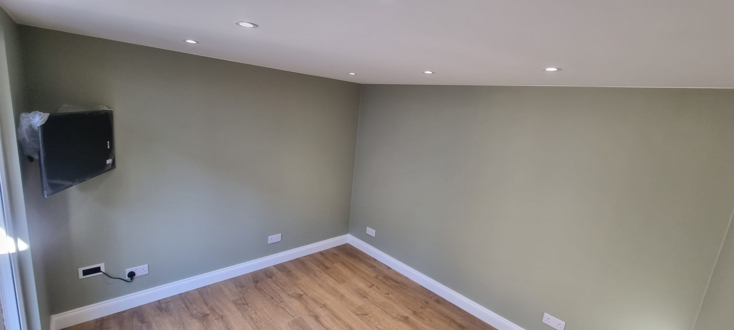 Completed garden room interior in Southend-on-Sea with finished walls and lighting