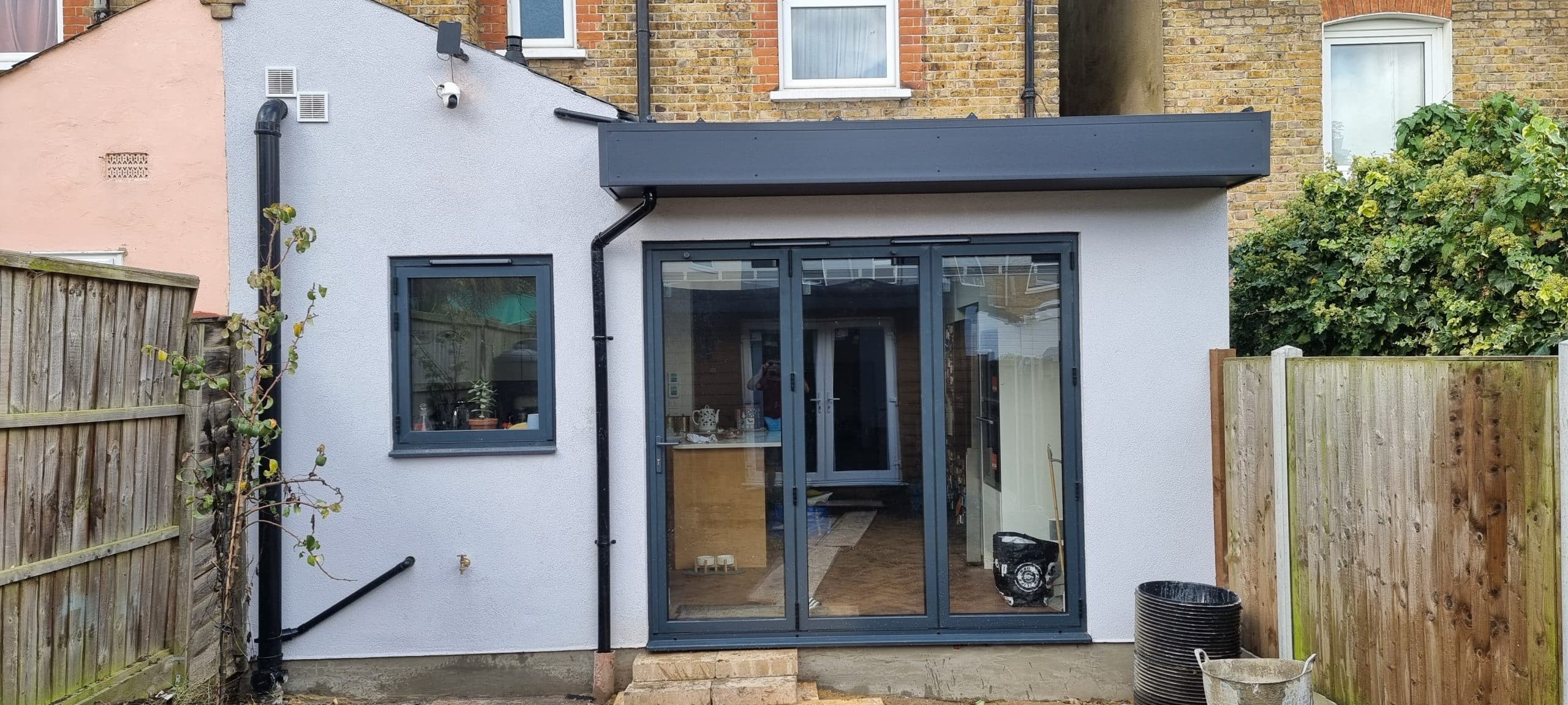 btom-rear-extension-timber-structure-build-southend Rear extension with aluminium bifold doors Southend