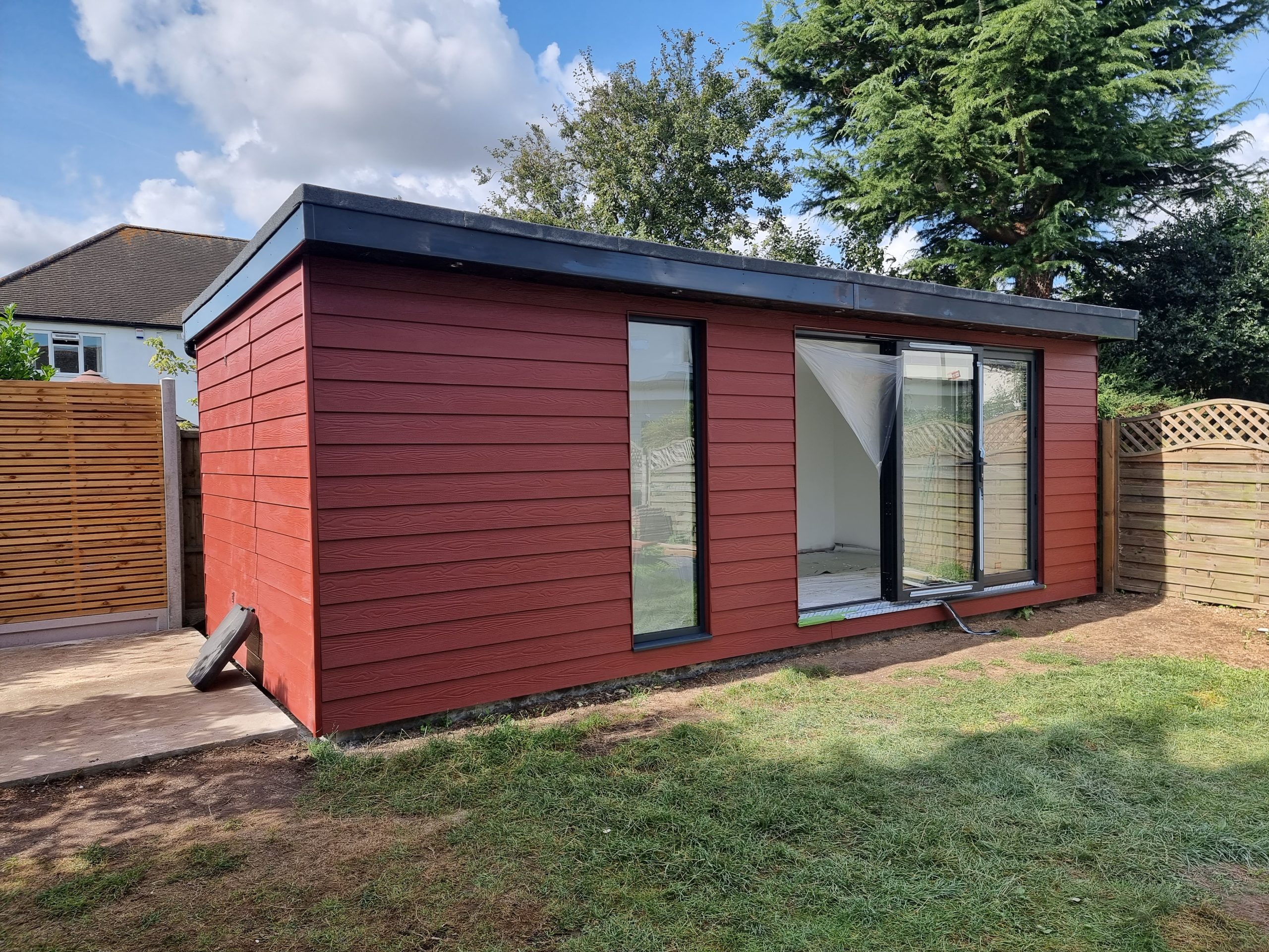 Modern garden room in Southend-on-Sea with coloured external cladding and slim glazing